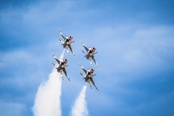 Air show planes flying in formation in blue sky