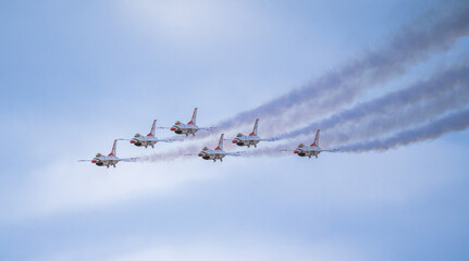 Air show planes flying in formation in blue sky