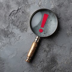 Magnifying glass with red exclamation point on textured surface