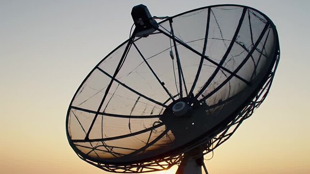 Satellite Dish Against a Clear Sky During Sunset Hour Communication Technology Antenna Silhouette Evening Sky Golden Light Telecommunication