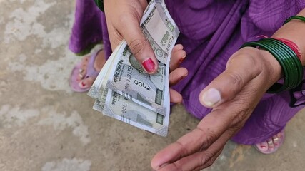 Indian female counting 500 rupees Indian currency notes	