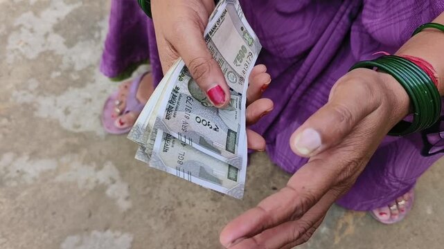 Indian female counting 500 rupees Indian currency notes	