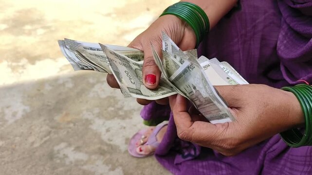 Indian female counting 500 rupees Indian currency notes	