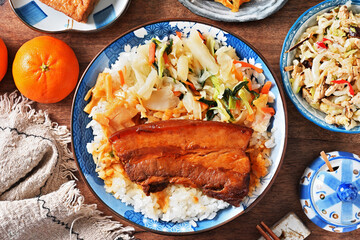 Braised pork belly rice is a beloved Taiwanese dish featuring a thick slice of soy-braised pork belly served over steamed white rice.