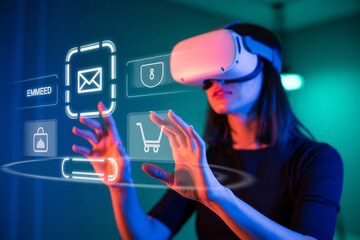 Young woman using virtual reality headset to interact with futuristic digital interface and icons