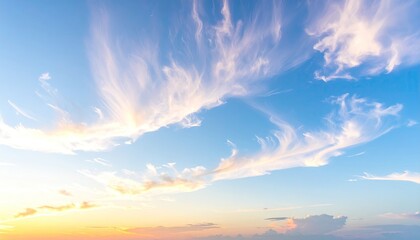 Fototapeta premium Soft, wispy clouds against a vibrant sunset sky