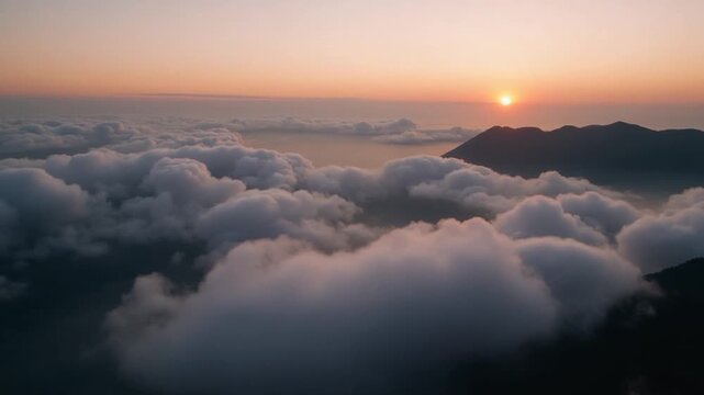 Aerial View of Mountains Above the Clouds at Sunrise. In the Mongkrang Hills, Indonesia