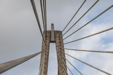Architectural detail of the Mahkota II (Achmad Amins) Bridge in Samarinda, Indonesia. This dramatic low-angle shot highlights the grand concrete pylon and geometric pattern of a cable-stayed bridge