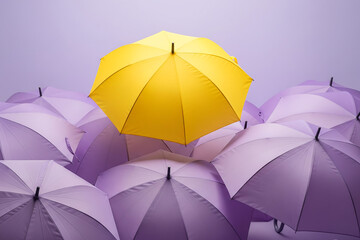Bright yellow umbrella stands out among many purple umbrellas