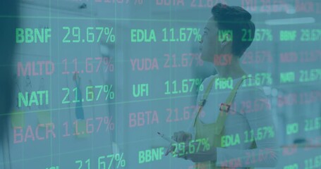 Male painter wearing yellow overalls painting canvas as stock % climbing guiding brush adjustments - Powered by Adobe