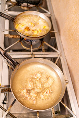 Frying food in hot oil on restaurant stove