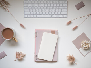 Pink and beige feminine workspace, pastel toned computer desk flat lay top view	