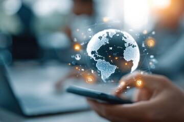 Hands holding phone, digital globe with network overlay.  Blurred office background