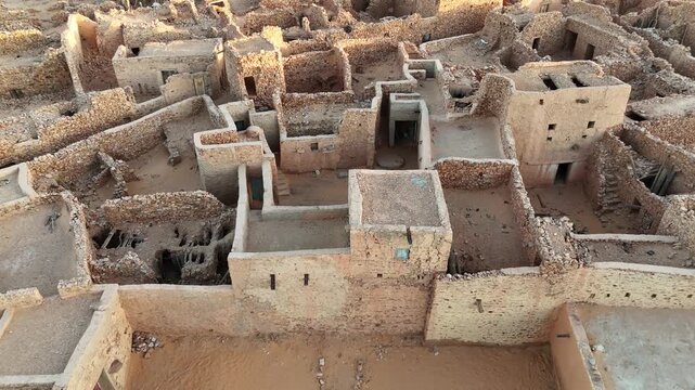 drone close-up of ancient stone houses and narrow streets in Chinguetti, Mauritania, UNESCO World Heritage desert town with historic architecture