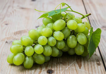 bunch of grapes on a wooden table