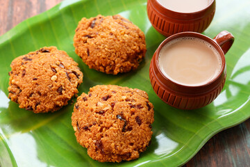 Parippu Vada or Paruppu Vadai made with toor dal. Kerala fried snacks savory food on banana leaf on dark black background. Kerala tea time food fried in coconut oil. Top view of South Indian snacks.