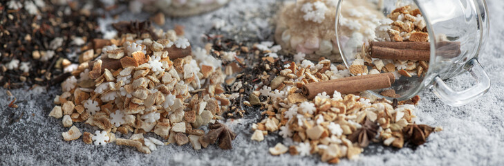 heap of sweet ingredients and spices for winter hot drink preparation on snowy background
