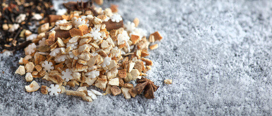 heap of sweet ingredients and spices for winter hot drink preparation on snowy background
