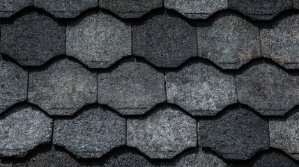 Naklejka premium Dark shingles arranged in an elegant pattern cover a building roof blending style and functionality in contemporary architecture. The geometric design adds visual interest.