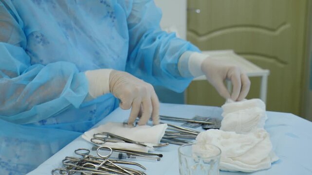 Medical nurse preparing tools for childbirth by caesarean section. doctors surgeon performing incision on patient abdomen stomach in hospital clinic. 4 k video