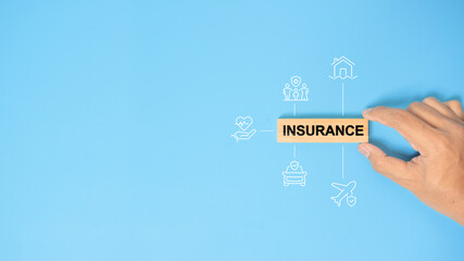 hand holding a wooden block with text insurance, different type of insurance icons. Insurance concept, different type of insurance background.