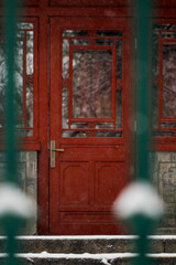 old red wooden door on building wall