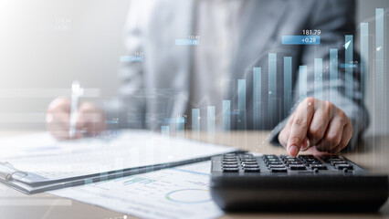 Businessman analyzing financial reports with calculator and growth chart, symbolizing investment...