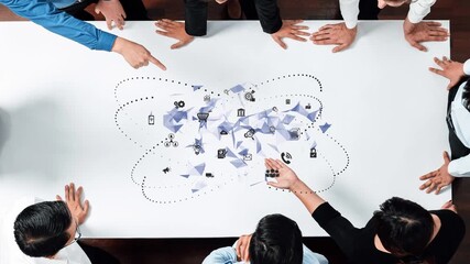 A diverse group of professionals engages in a collaborative brainstorming session over a white table, surrounded by digital network icons and concepts. Raster - Powered by Adobe