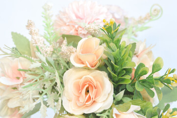 Close up of a bouquet of soft and attractive colored roses on a white background