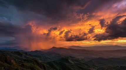 Fototapeta premium A breathtaking sunset showcases vibrant oranges and purples in the sky as rain clouds gather over a mountainous landscape. The scene captures the beauty of nature at dusk.