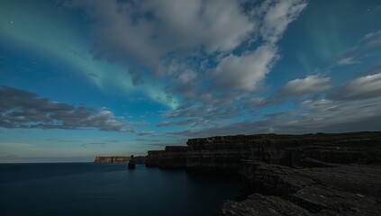 Majestic coastal scene at twilight, illuminated by an ethereal aurora borealis display over dark cliffs and a calm sea.