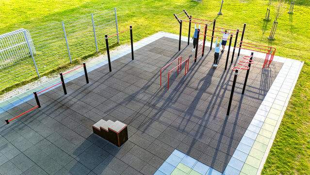Outdoor gym for street workout aerial drone view, modern sports ground with bars and equipment for outdoor fitness and exercise, active people working out in calisthenics park outdoors - Powered by Adobe
