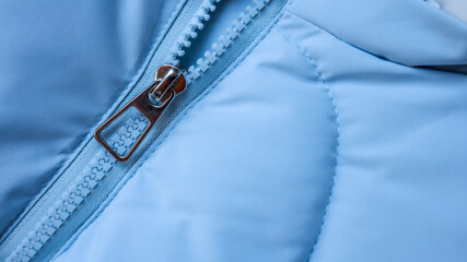 Close-up of a blue jacket zipper