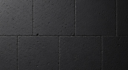 Fototapeta premium Textured surface of honed basalt tile, dark charcoal color, slightly rough and uniform finish, natural stone, macro shot