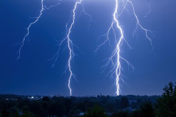 Powerful lightning strikes illuminate the night sky during a thunderstorm