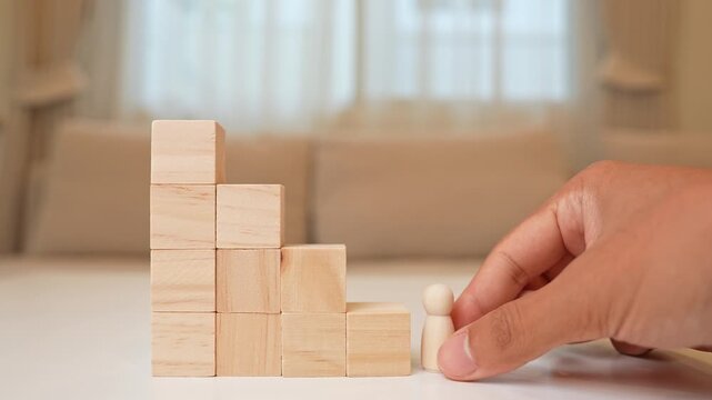 A wooden figure stands at the base of descending block steps, symbolizing stagnation, career decline, lost momentum, challenges in progress, resilience, and the importance of adapting to change.
