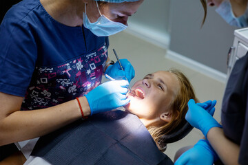 Young patient receives dental treatment in a modern clinic setting during daylight hours