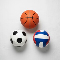 Flat lay of basketball, soccer ball, and volleyball arranged with clean minimal style