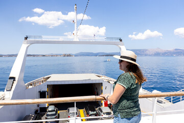 Relaxed female traveler admiring breathtaking sea views from ferry deck