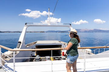 Relaxed female traveler admiring breathtaking sea views from ferry deck