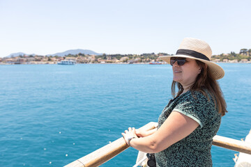 Woman enjoying mediterranean ferry boat journey with scenic ocean views