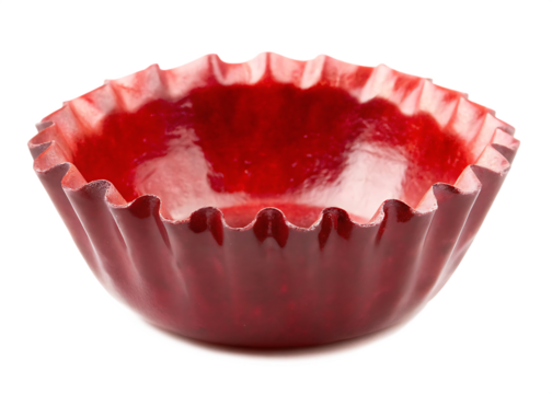 Shiny red fluted baking cup with dark background isolated on a transparent background