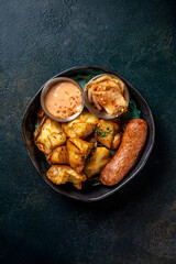 Sausage with roasted potatoes, kimchi, and sauce