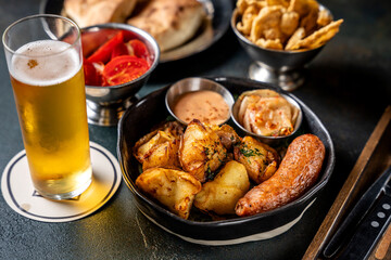 A pub meal with a glass of light beer.