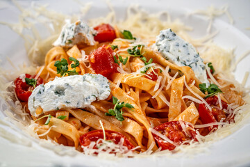 Tagliatelle pasta with ricotta, cherry tomatoes and parmesan