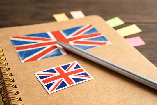 UK flag with pen on english language book.