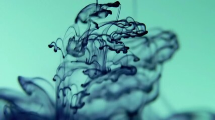 Hypnotic dark blue ink plumes elegantly unfurling and swirling into a serene cyan liquid, creating mesmerizing abstract underwater art and organic diffusion patterns - Powered by Adobe