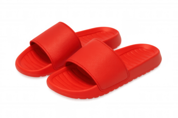 Pair of red comfort slides for summer footwear, casual plastic sandals for beach or poolside wear