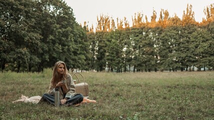 Young woman enjoying a picnic in a serene park setting