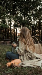 Woman enjoying a peaceful picnic in the park during autumn